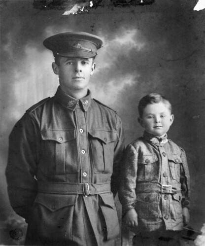 Studio portrait of 1626 Private (Pte) Walter Henry Chibnall, 10th Light Trench Mortar Battery, pictured with his son William Beresford (Billy) Chibnall