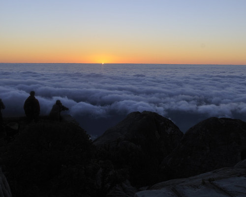Sun sets over the clouds around Table Mountain