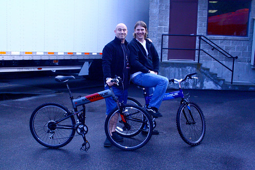 As proud owners, two of the crew members pose with their new Montague folding bikes.