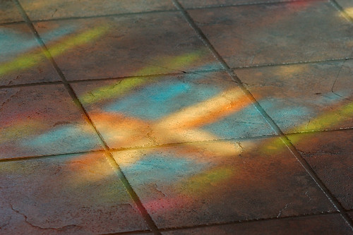 Light from stained glass window upon tile floor, at Saint Peter Roman Catholic Church, in Saint Charles, Missouri, USA