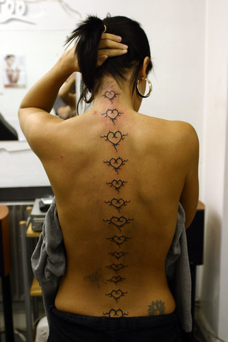 Female Spine Tattoo of Hearts · Back Tattoo on Spine of Girl