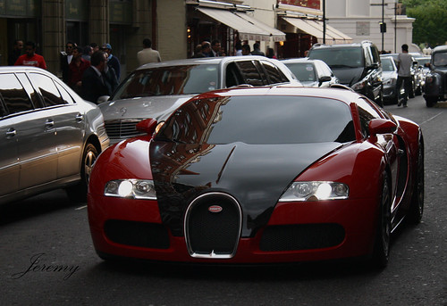 Red and Black Bugatti Veyron go back