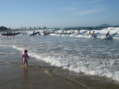 A kayaker club prepares to launch into the surf