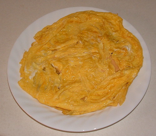 Six eggs in a two-layer omelette with some cheese.