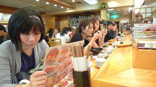 Yuan Yue looks at the menu