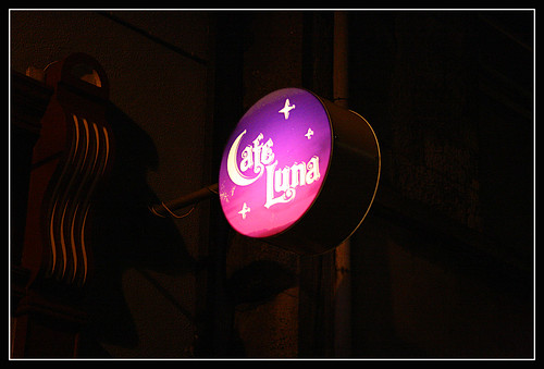 Cafe Luna sign at nighttime - pink and purple, with a half-moon for the letter C, and some stars around the edge