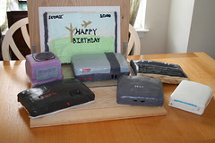 Video Game console cakes in front of 