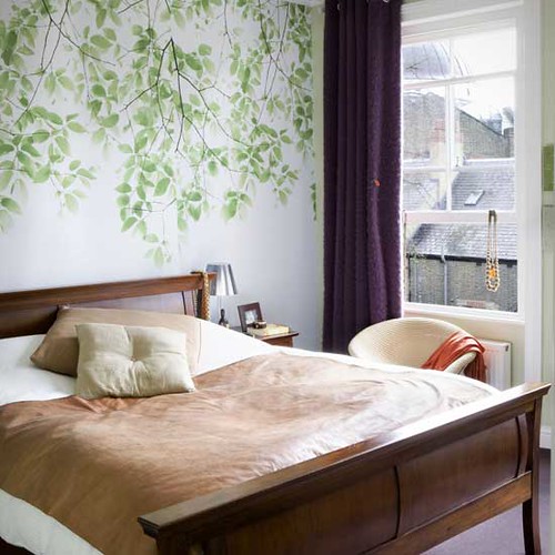 Lovely bedroom: Modern leaf wallpaper + neutral linens + sleigh bed