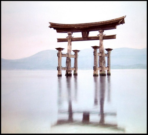 THE OLD TORII IN THE SEA AT MIYAJIMA FLOATS ABOVE ITS REFLECTION in OLD JAPAN