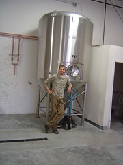 Joel Vandenbrink of Two Beers Brewing poses next to his shiny new fermenter.