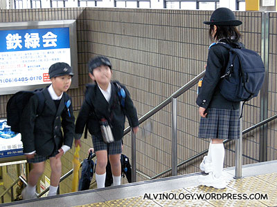 Kids in uniform at the train station