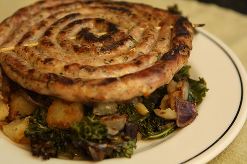 Grilled Rope Sausage with Carmelized Onions, Potatoes, and Kale