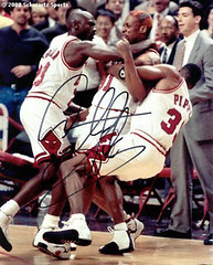 Dennis Rodman gets tackled by Michael Jordan and Scottie Pippen