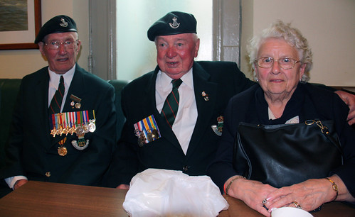 Three veterans sheltering from the rain, Arromanches, Normandy, D-day commemorations 2009