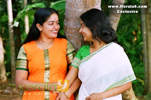 Kavya Madhavan and Meera Jasmine with Kerala backdrop