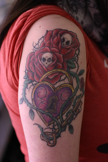 new school roses, skulls, lock, key and vines tattoo