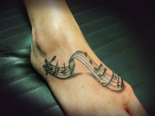 toe tattoos. music tattoos on foot.