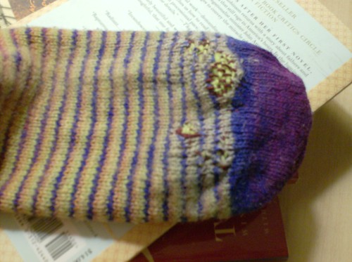 Darned helical stripe handspun socks with a mended hole at the toe