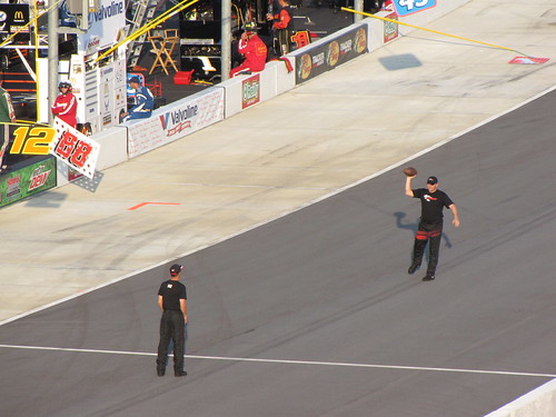 Crew members tossing a football before the race