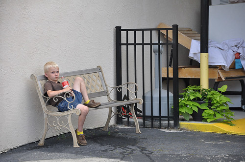 A boy sits outside of a store on Main Street in Hayeseville, North Carolina.