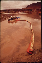 Oil Slick on the San Juan River Just Above Log Boom. A Burst Pipeline at Shiprock, New Mexico, Spilled About 285,000 Gallons of Crude Oil. The Oil Flowed Downstream More Than 200 Miles before the Booms Contained It. EPA Supervised Clean - Up of the San Ju by The U.S. National Archives