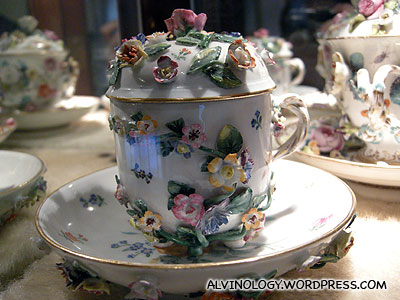 A cup heavily ornated with flowers