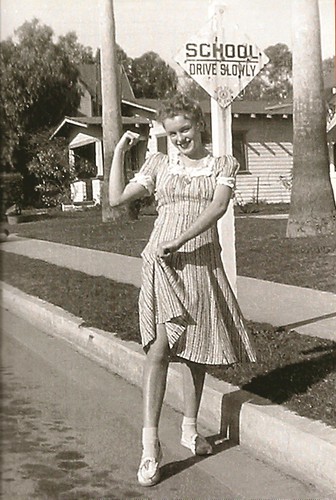 Norma Jeane playfully strikes a hitchhiking pose c 1941