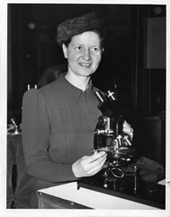 Wanda Margarite Kirkbride Farr (b. 1895), sitting in lab with microscope