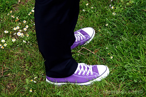 Black suit and purple Converse in grass at a Tuscan wedding