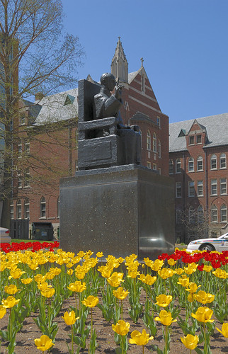 Statue of  the Venerable Pope Pius XII, at Saint Louis University, in Saint Louis, Missouri, USA - statue with tulips in bloom