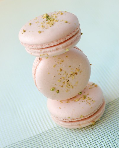 an Arabesque macaron, filled with a dollop of apricot jelly and white chocolate pistachio ganache