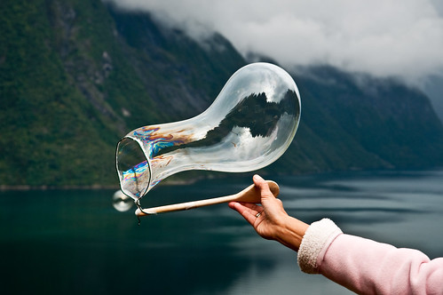 Creating soap bubbles over the fjord with a string and a spoon by Odinodin.com