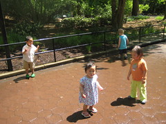 Kids running through sprinklers to cool off
