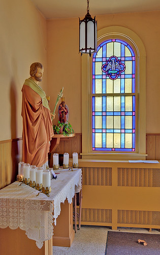 Immaculate Conception (Saint Mary's) Roman Catholic Church, in Brussels, Calhoun County, Illinois, USA - statue of Saint Joseph and window with eagle and fish symbols