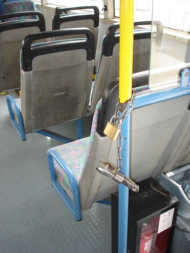 A hole puncher at the rear door of the bus