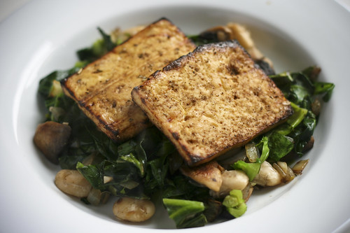 Grilled Tofu on Spring Greens Sauteed with Onion, Garlic, Mushrooms, Butter Beans, and Thyme