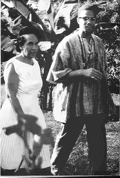 Malcolm X of the Muslim Mosque, Inc. and Shirley Graham DuBois, Director of Ghana National Television, at her villa in Accra, Ghana during Malcolm's visit in May 1964. DuBois had thrown a reception in his honor. by Pan-African News Wire File Photos