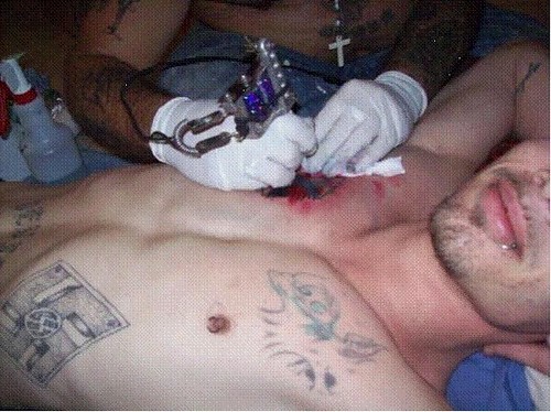  Aryan Circle member getting a tattoo 