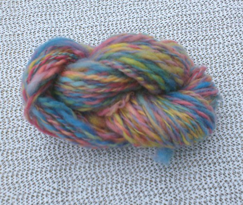 Skein of blue red yellow pink green purple handspun wool yarn