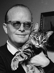 Truman Capote cuddles kitty 1967