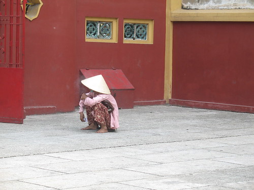 Crouched in a temple courtyard
