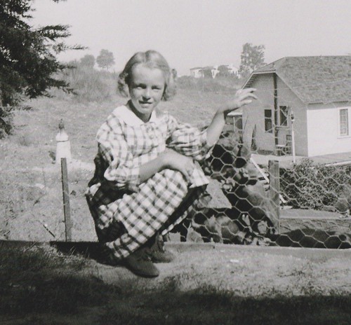Young Norma Jeane At age 7 playing with dogs in a country garden while in