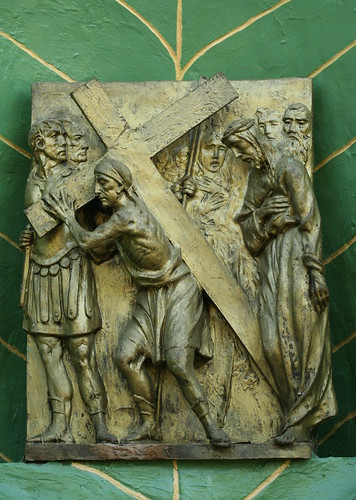 V. Simon of Cyrene carries the cross