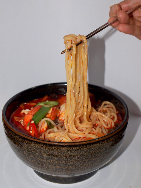 Mum's hand; Korean Chopsticks; Noodles. photo