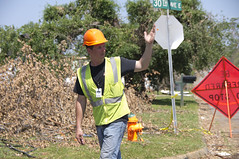 Contractor directs traffic during debris clean...