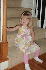 sitting on the stairs in her Easter dress
