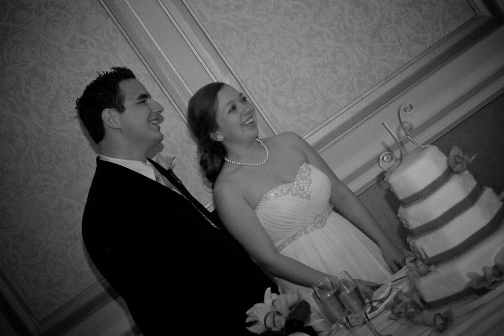 Happy sweet couple getting ready to cut the cake at intimate wedding reception at Omni Hotel Richmond Virginia