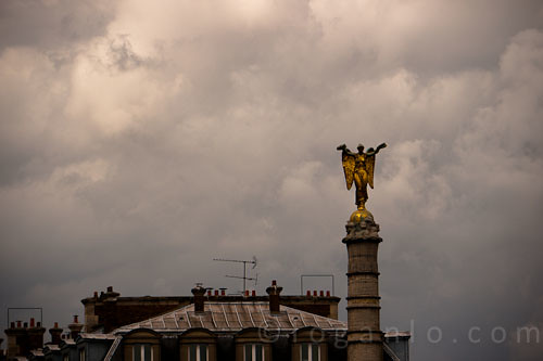 Statue against a cloudy Paris sky in France