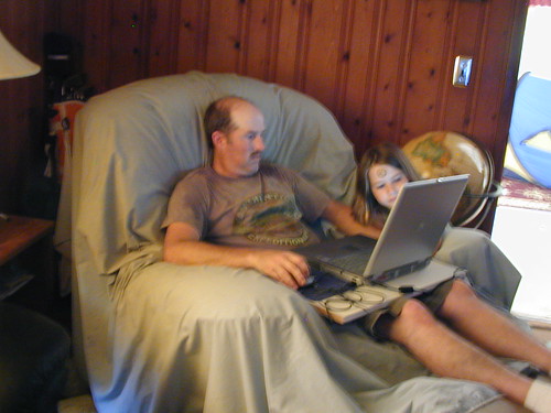 The Computer Geek surfs as my Granddaughter looks on.
