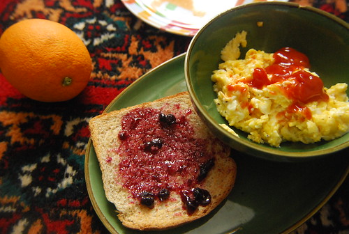 Scrambled eggs, toast, orange